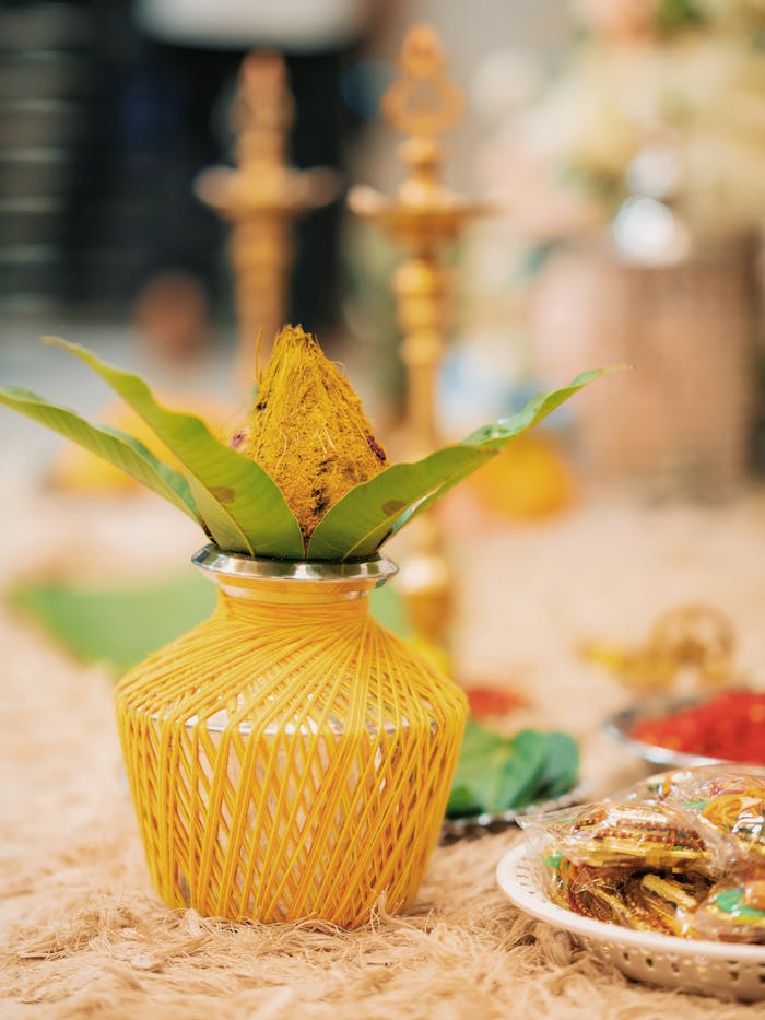 A beautifully decorated Kalash with leaves and flowers, symbolizing Indian traditions